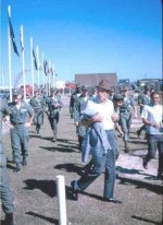 Bob Hope heads for mess hall Dec 1964, Cpt. Chuck Shipman (hands on hips) and white knight ce's
